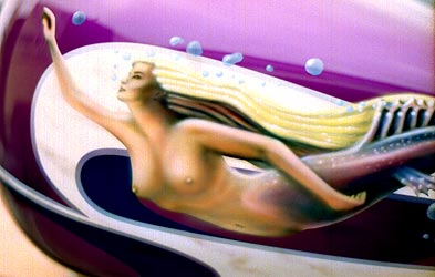 graphics and mermaid on Harley Davidson motorcycle tank close up